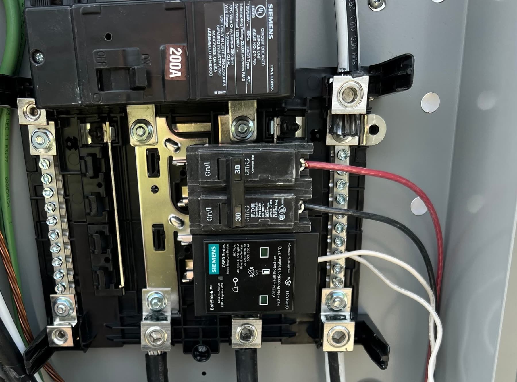 Opened 200A electrical panel with breakers and neatly landed conductors