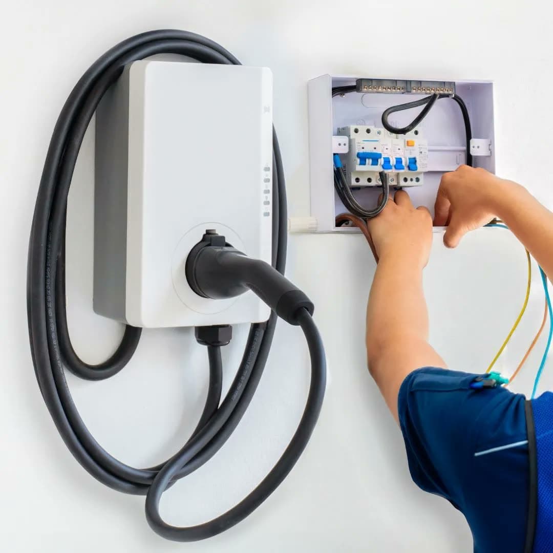 Wall-mounted EV charger beside its dedicated circuit