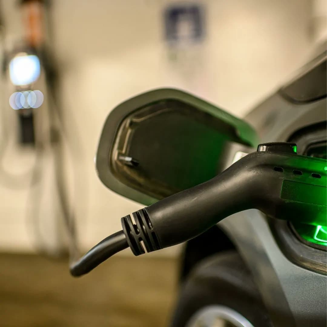 EV charging connector plugged into an electric vehicle