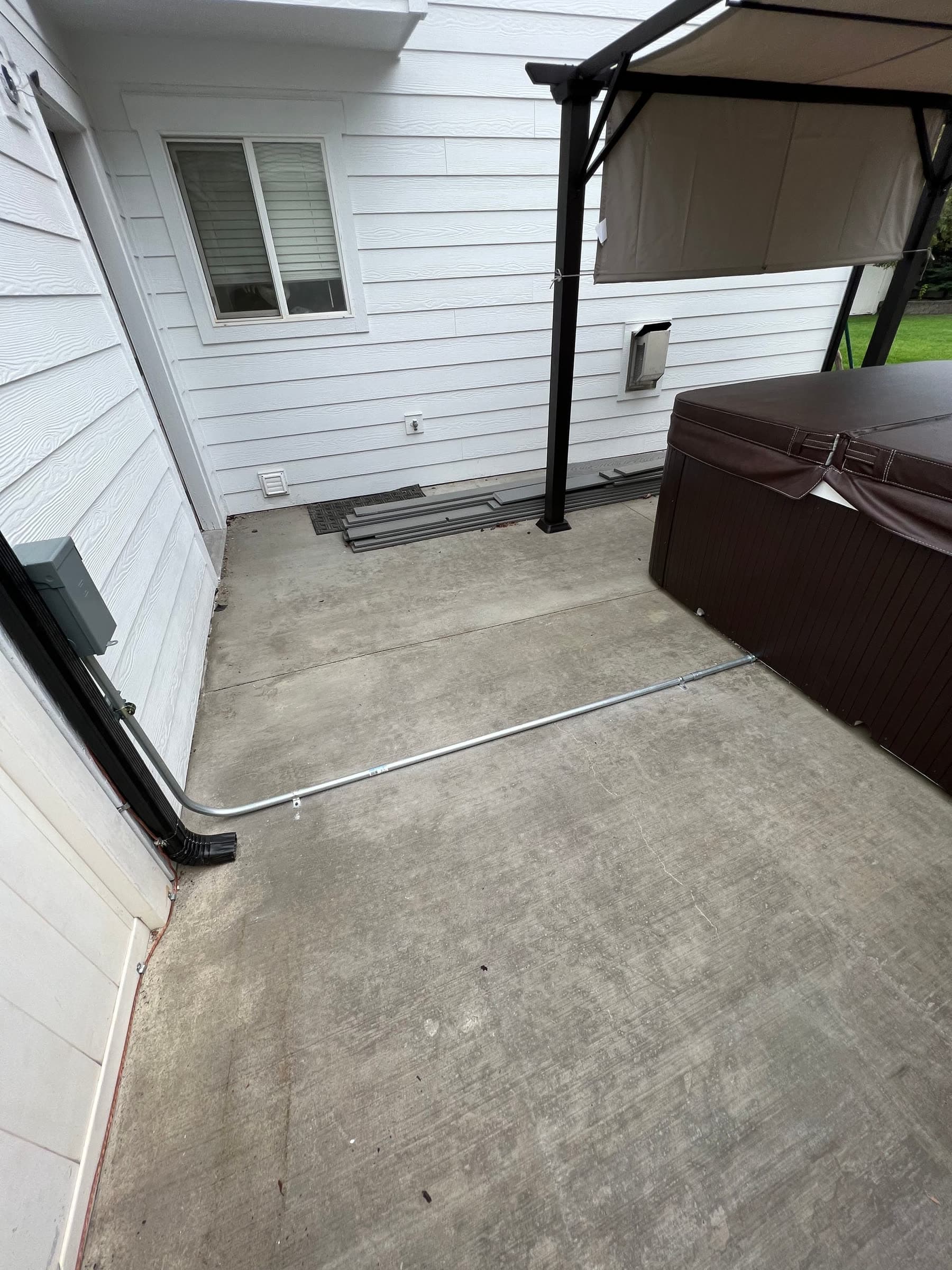 Hot tub with disconnect and conduit run on a home patio