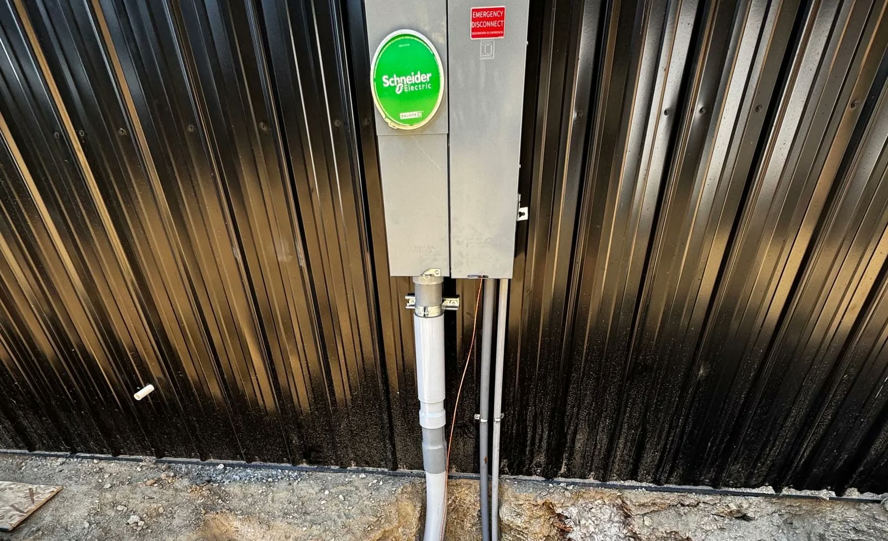 Commercial service disconnect with conduit on a building exterior